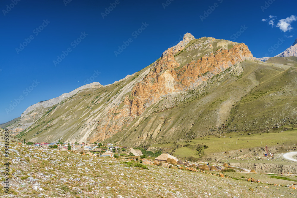 Sunny view of mountains and Eltyulbyu village in North Caucasus, Kabardino-Balkaria, Russia. Sunny view of mountains and Eltyulbyu village in North Caucasus, Kabardino-Balkaria, Russia.
