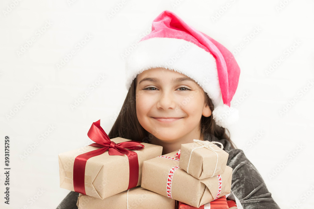 Happy smiling child girl Santa with Christmas boxes on white background. Positive face Happy smiling child girl Santa with Christmas boxes on white background. Positive face