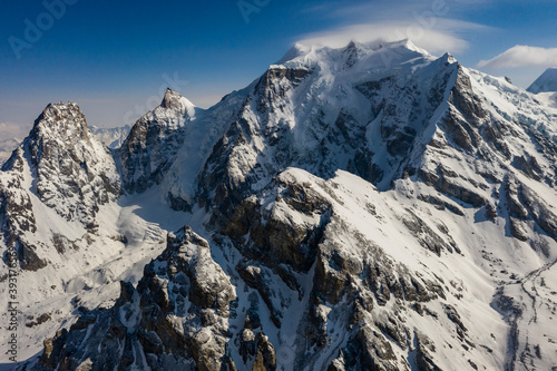 Steep snow covered alpine mountain landscape in the Nepal Himalaya photo