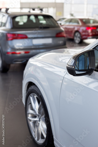 Car auto dealership. Themed blur background with bokeh effect. New modern cars. © tikhomirovsergey