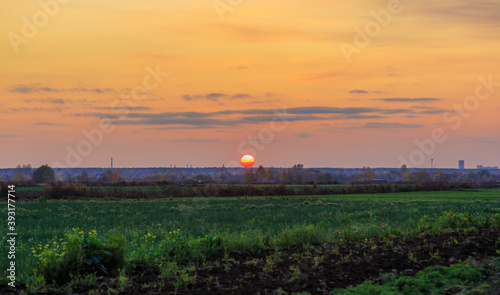 Sunset, the sun sets over the horizon, rural landscape. photo