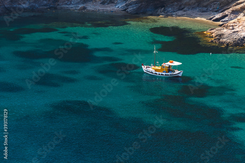 Traditional fishing boat at the beach near Agios Ioannis Thermastis. photo