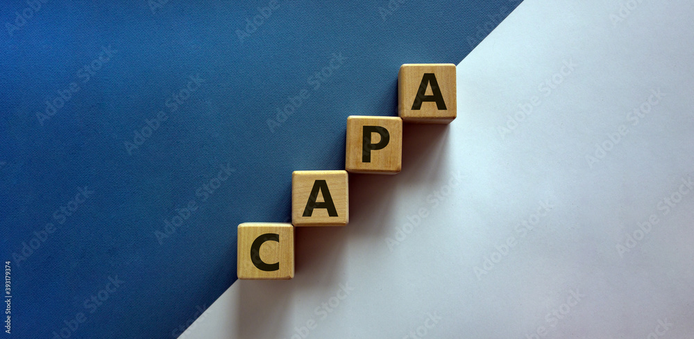 Ταπετσαρία Concept words 'CAPA, corrective and preventive actions' on wooden cubes on a beautiful white and blue background