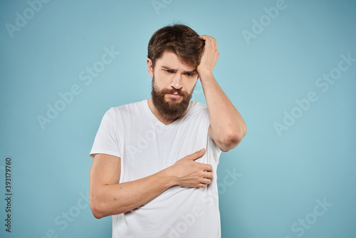 Man in white t-shirt lifestyle studio emotions facial expression blue isolated background