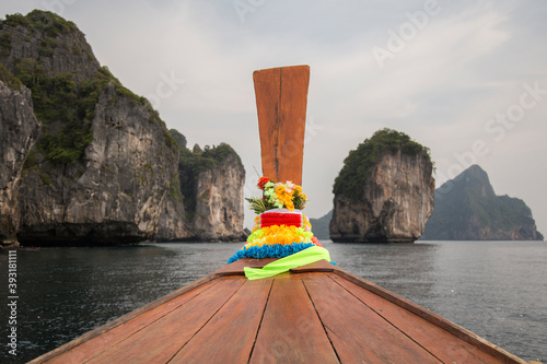 Colorful garland on front of Thai long tail boat at Ao Nang bay photo