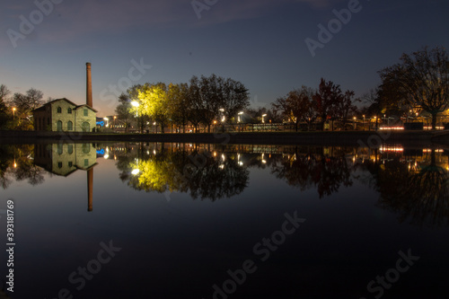 Museum of electricity in the city of viseu at night, reflecting its image in a local lake, City of Viseu, Portugal