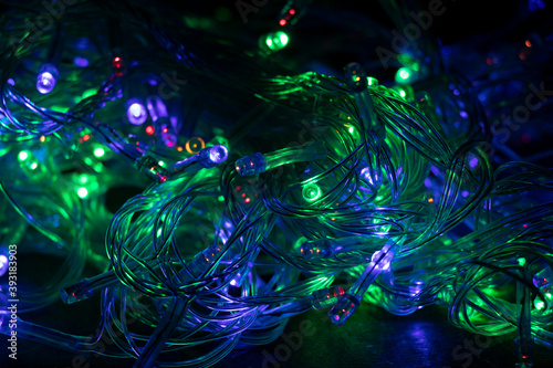 Colorful multicolored Christmas lights background. Holidays. © Yuliia