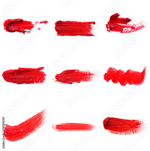 Lipstick smear smudge swatch isolated on white background. Cream makeup texture.