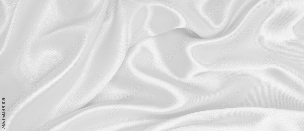 Smooth elegant white silk or satin luxury cloth texture as wedding background. Luxurious background design