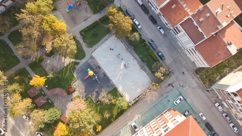 Aerial view of the street basketball court and children's playground in the city. 