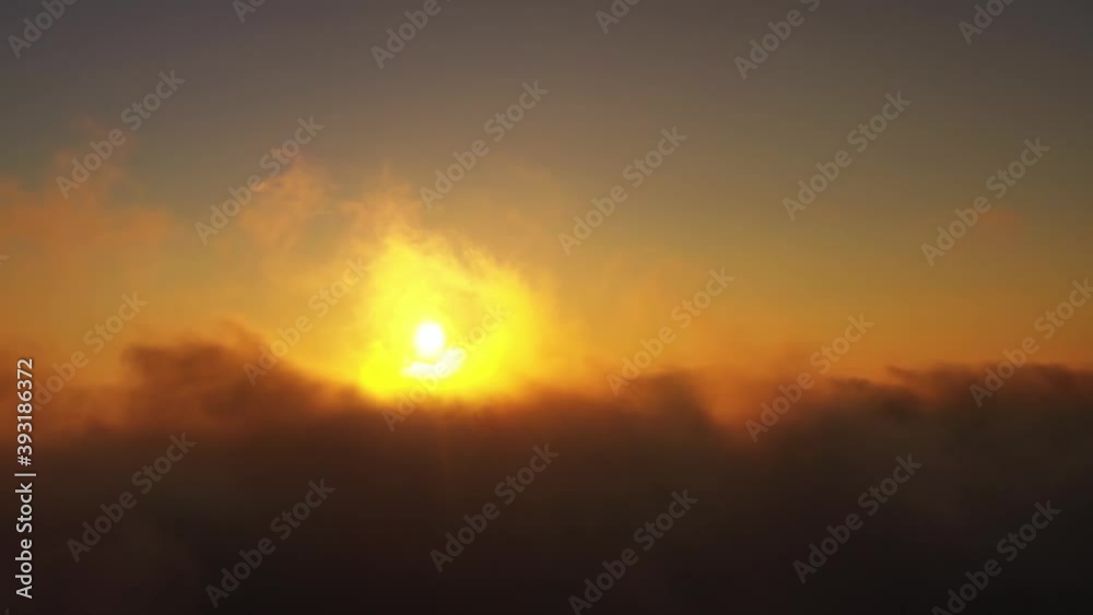 View on the endless cloudscape. Aerial view of morning sun in bright colors above he clouds. View on the endless cloudscape. Aerial view of morning sun in bright colors above he clouds.