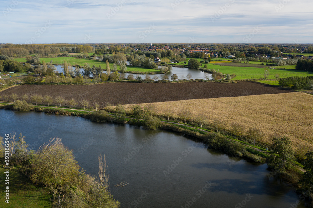 Old Durme meanders, in Waasmunster, Belgium; aerial view; the town of Hamme can be seen in the background