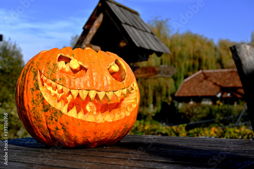 Halloween pumpkin on wood in a spooky village