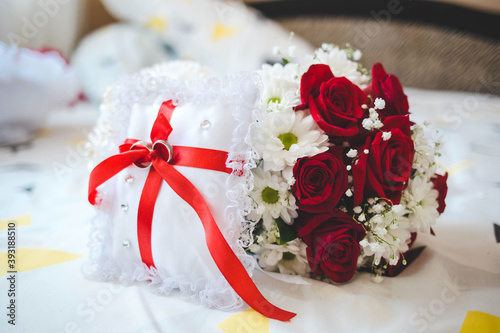 Selective focus shot of flowers and symbolizing wedding rings in a box photo