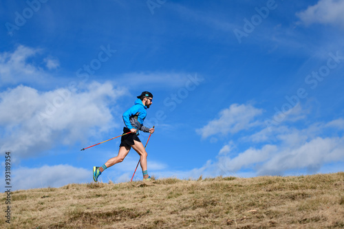 Endurance mountain race. a man with climbing poles