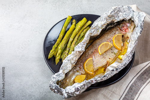 Fresh baked salmon trout in an aluminum foil photo