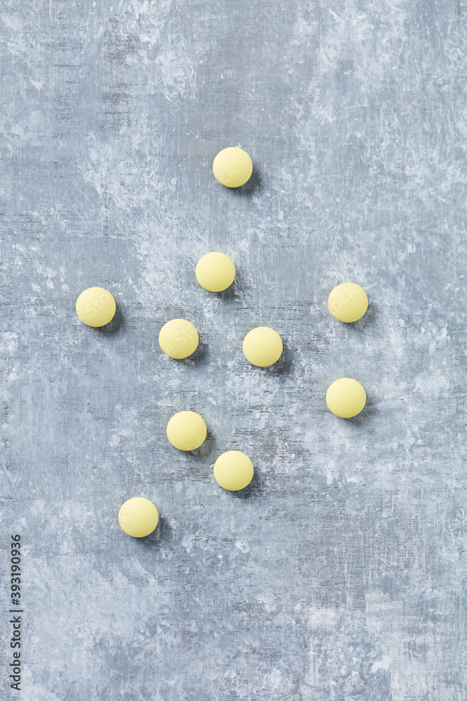 Vitamin C tablets on  wooden background. Top view. Copy space. 