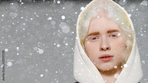 snow, winter, christmas, people, beauty concept - beautiful albino girl with white skin, natural lips and white curly hair wearing stylish white sweater,copy space, beauty. 16:9 panoramic format.
