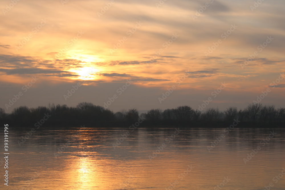 Beautiful sunrise on the Vistula River, Chelmno, Poland, reflection in water.