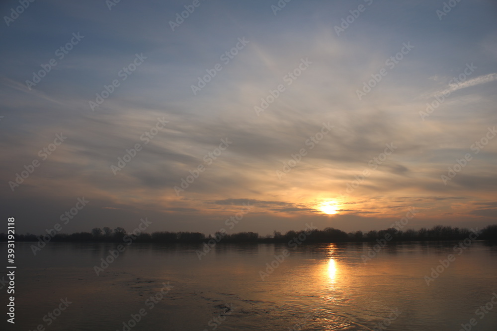 Beautiful sunrise on the Vistula River, Chelmno, Poland, reflection in water.