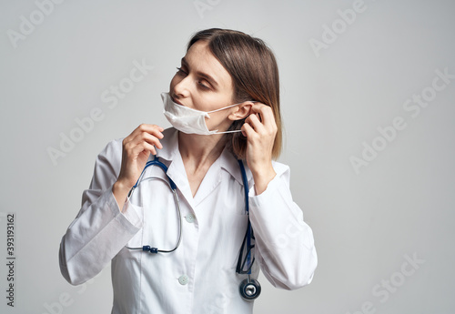 Doctor with medical mask on his face stethoscope laboratory equipment