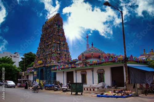 Pondicherry, India - October 30, 2018: Wide angle shot of An Indian colorful temple named Vedapureeswarar exterior displaying beautiful hindu architecture with gods sculpture carved on it's built. photo