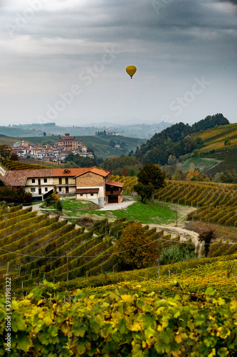 the castle of barolo, in the heart of the Piedmontese Langhe near Alba and in the background a hot air balloon in the skies