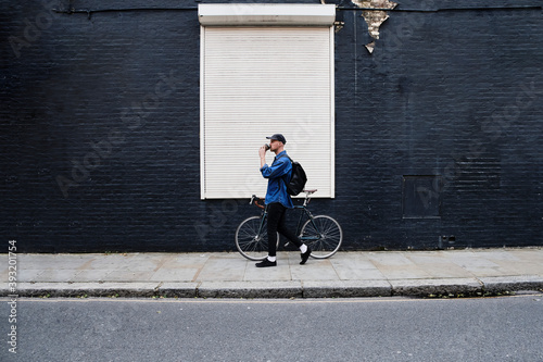 Photography Young Professional Man Walking With His Bike And Drinking Coffee Outside In The City