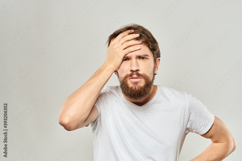 man in white t-shirt gesturing with his hands studio dissatisfaction lifestyle light background