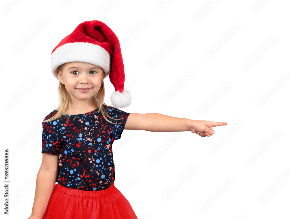 Smiling little girl in Santa hat points finger isolated on white background. Smiling little girl in Santa hat points finger isolated on white background.