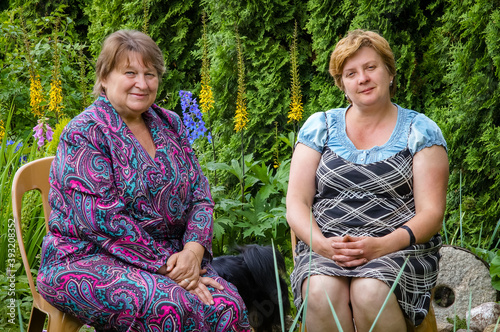 Two nice Mature women relax in a city Park.