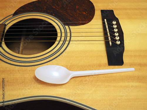 one-time spoon on a guitar, the concept of making money on food. closeup
