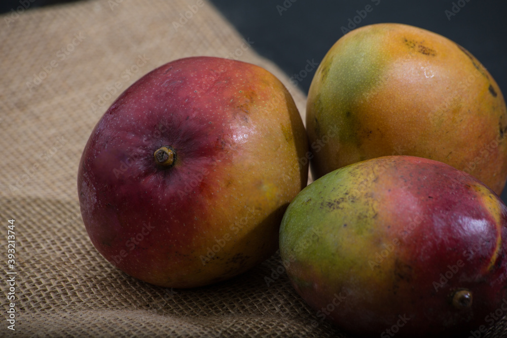 table with mango fruits. dark background with space for text table with mango fruits. dark background with space for text