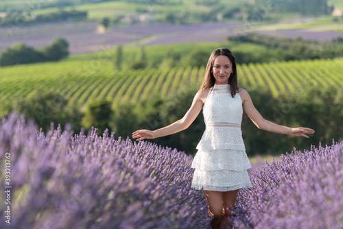 jeune fille en robe blanche au milieu d'un  champ de lavande