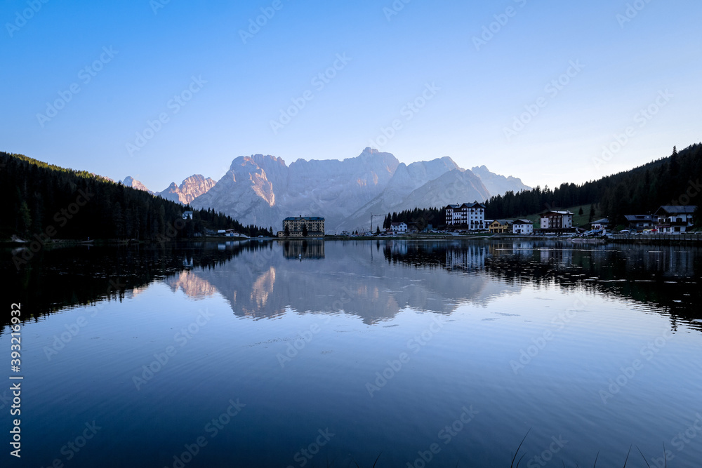 Evening mood at Lago di Misurina (Misurina Lake) with mirror lake reflections of the alpine mountain panorama of the Dolomites in Misurina, Veneto, northern Italy. 