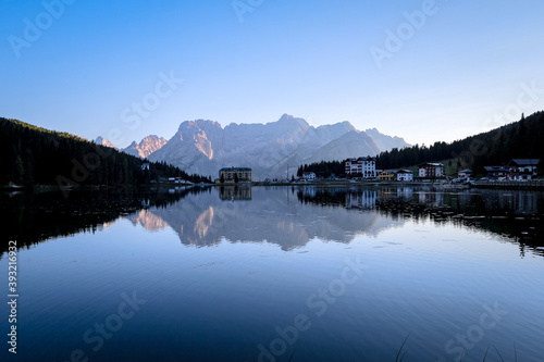 Evening mood at Lago di Misurina (Misurina Lake) with mirror lake reflections of the alpine mountain panorama of the Dolomites in Misurina, Veneto, northern Italy. 