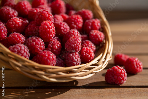 raspberries in a reed basket in the sun