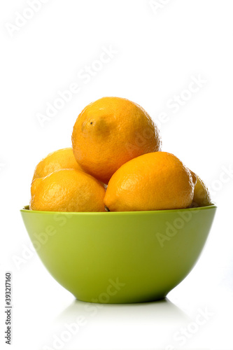 Studio shot of lemons in green bowl