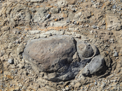 Volcanic bomb embedded in eruptive sedimen photo