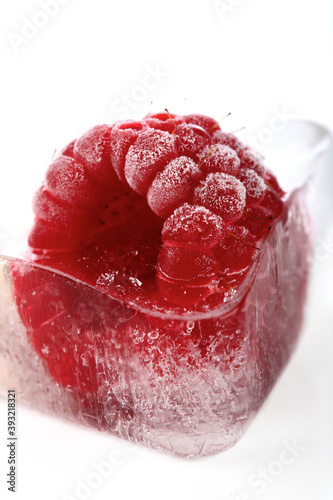 Frozen raspberry on white background