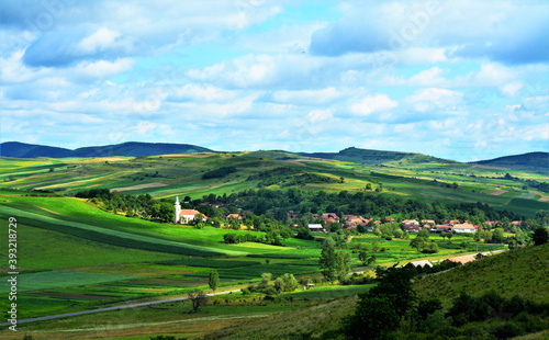 Foto Scenic rural landscape in Transylvania with a village in Mures county - Romania
