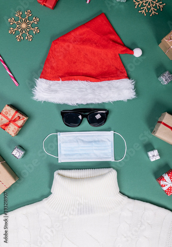red hat mask and white sweater flat lay shape of Santa Slaus photo