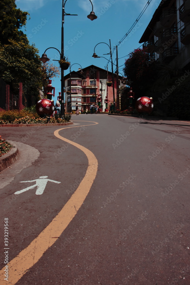 Fototapeta premium Gramado, RS, Brazil, October 18, 2020, Tourists walking along the famous Rua Torta decorated for the Christmas light festivities.