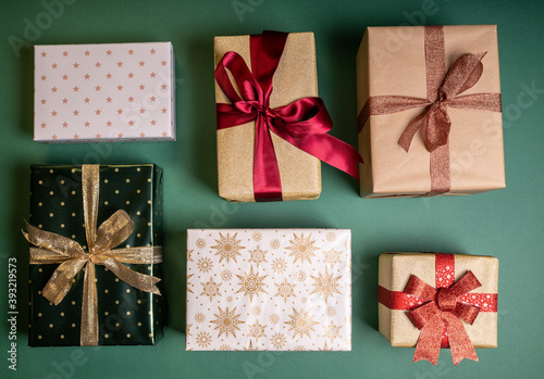 set of Christmas wrapped gifts on green background photo