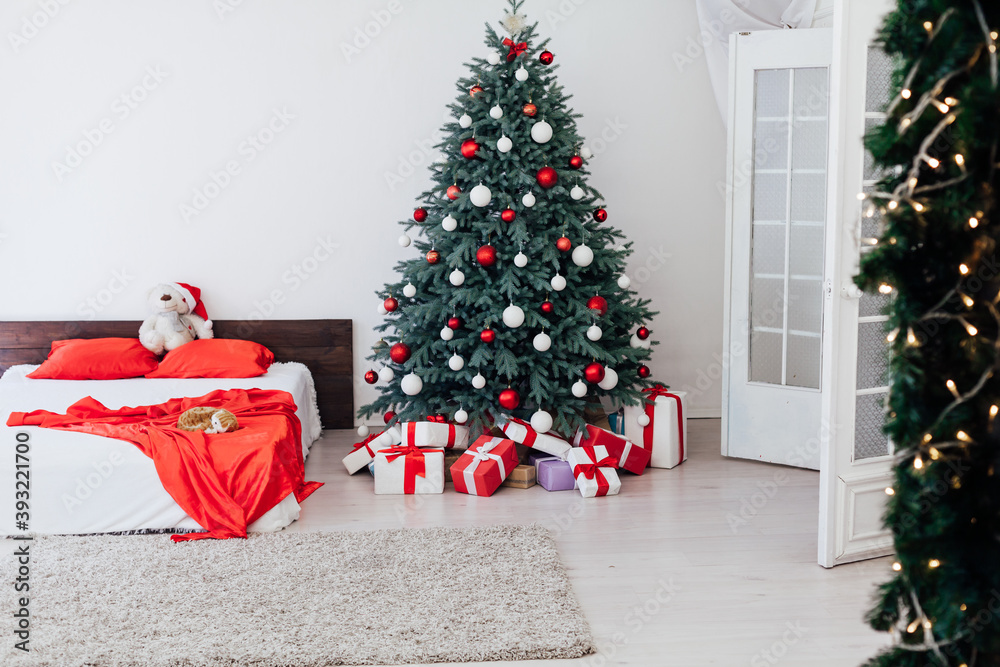 New Year's eve bedroom interior with red decor bed and Christmas tree with gifts