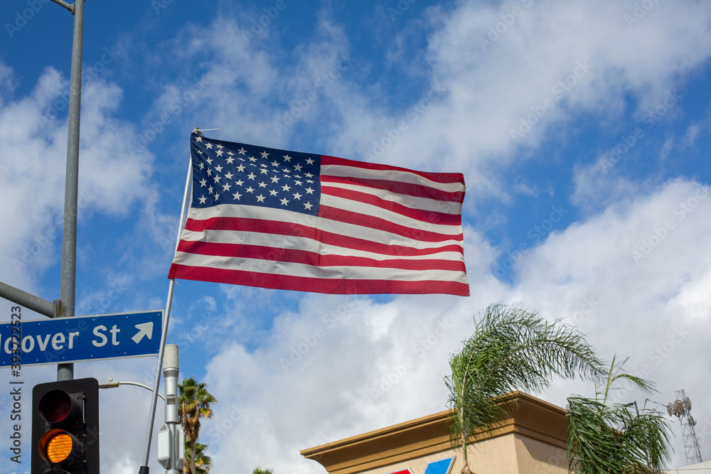 American flag flying in front of blue sky