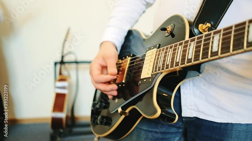 Close up of man playing guitar. Concert with a band