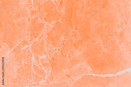 Orange wall with marble pattern. Stone surface texture background, toned