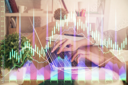 Double exposure of woman hands typing on computer and forex chart hologram drawing. Stock market invest concept.