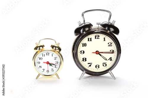 Fototapet Closeup shot of a two vintage alarm clock on a white background